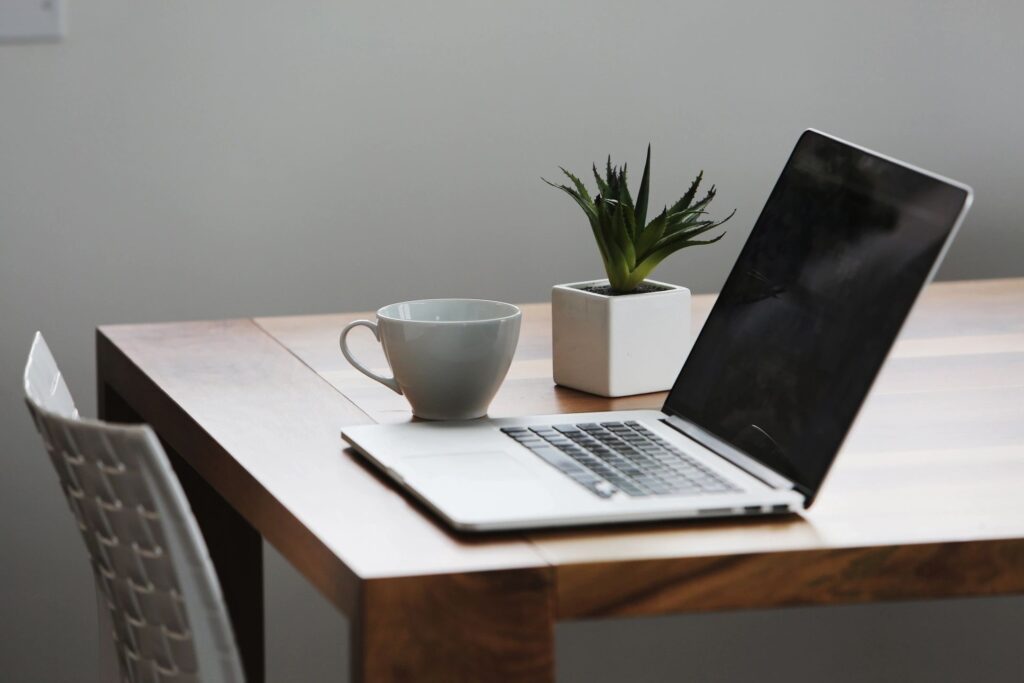 laptop on a desk with coffee