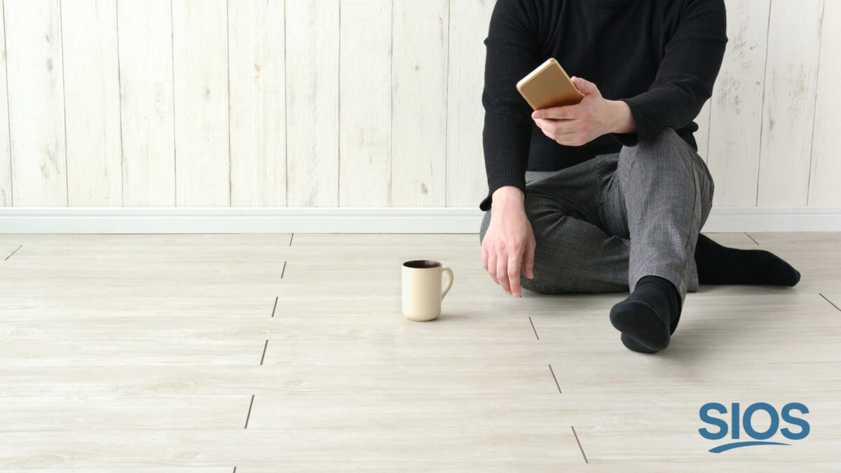 Man sitting using his phone, representing the idea that most people don’t care about your life